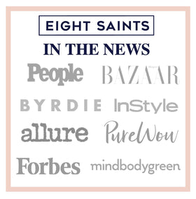 Eight Saints bottle on bathroom shelf styled with towels, promoting routine refreshment
