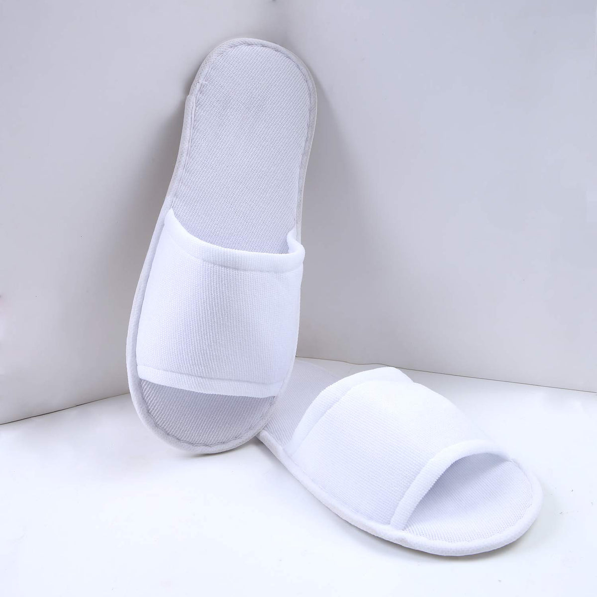 Elcoho slipper held by hand to show size and fit for most adults