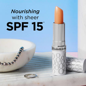 Elizabeth Arden lip stick beside sunglasses illustrating daytime protection