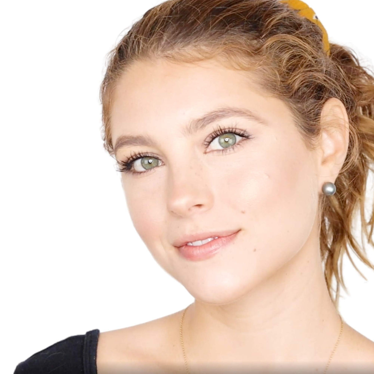 Elizabeth Mott applying bronzer to cheek demonstrating contouring and warm glow