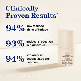 Embryolisse eye stick in hand for scale emphasizing portable size and on-the-go convenience