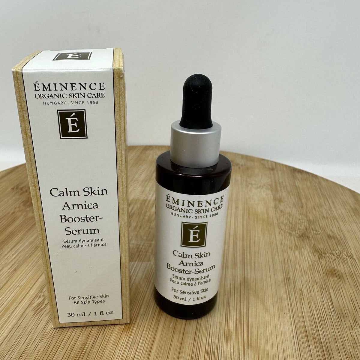 Eminence applying serum to cheek, gentle application soothes sensitized skin benefit