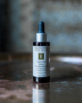 Eminence bottle beside arnica and chamomile, botanical ingredients clarity benefit