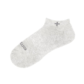 emuaid socks worn on foot in home setting showing moisture control benefit