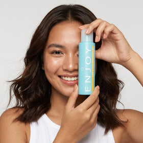 Enjoy bottle next to ruler for size comparison showing travel-friendly 3.4 oz benefit