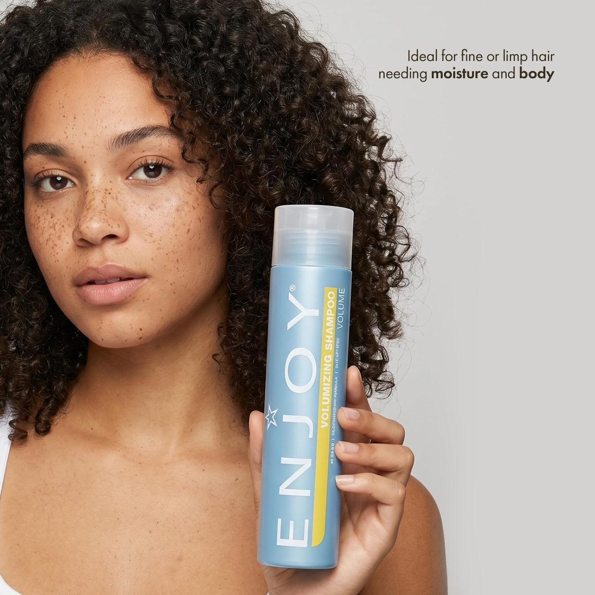 Enjoy bottle held in hand to show 10.1 fl oz size and travel-friendly benefit