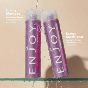 Enjoy shampoo bottle close-up highlighting pump and sulfate-free benefit