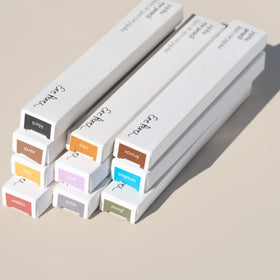Ere Perez flatlay with pencil and natural elements, clean beauty aesthetic displayed