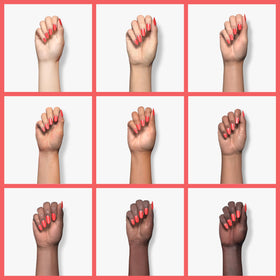 essie polished nails in Sunset Soiree vibrant orange-red showing longwear shine