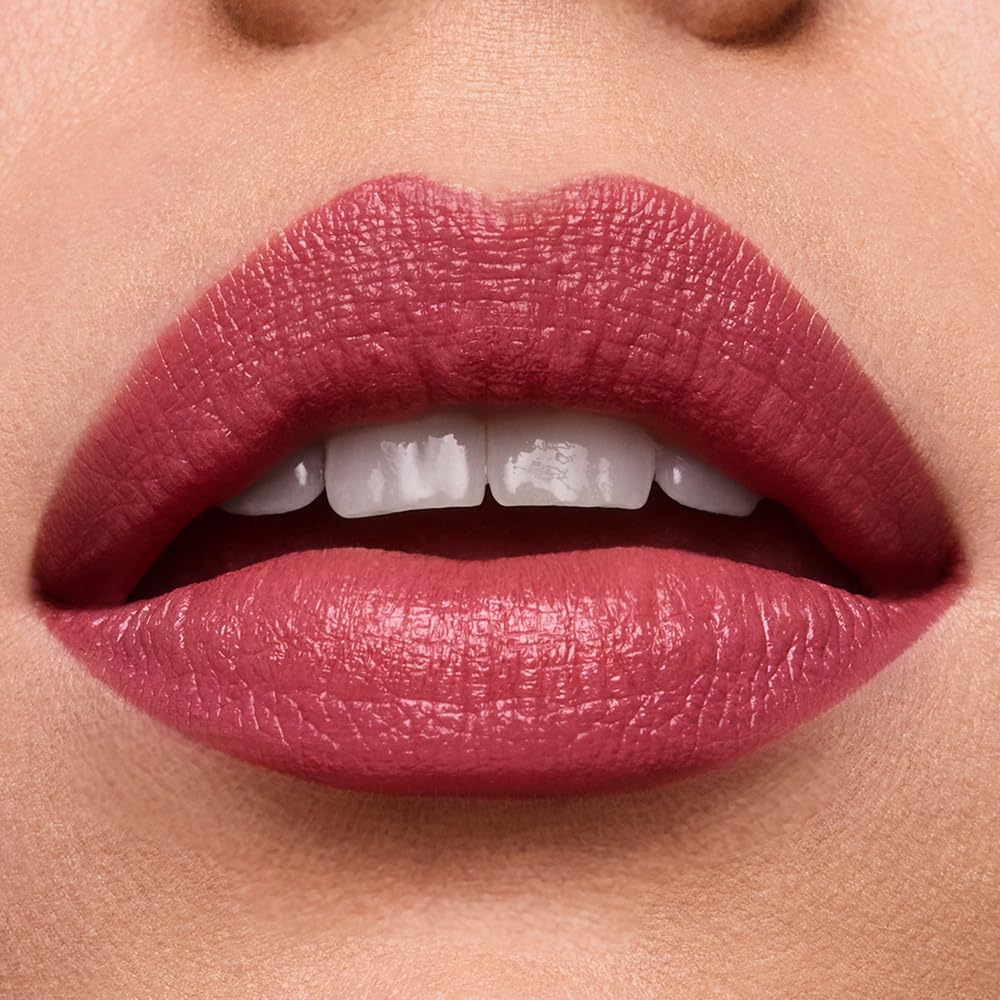Estée Lauder lipstick next to ruler for size and scale indicating portable, everyday convenience