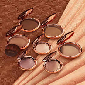 Estée Lauder compact next to coin showing product size and travel-friendly portability