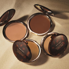 Estée Lauder bronzer on shoulders and décolletage for unified sun-kissed look