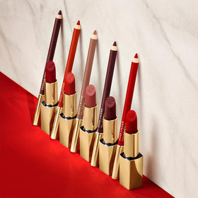 Estée Lauder liner beside a hand for scale showing compact size and on-the-go convenience