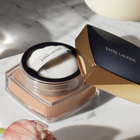 Estée Lauder loose powder texture close-up showing microfine silky finish benefit