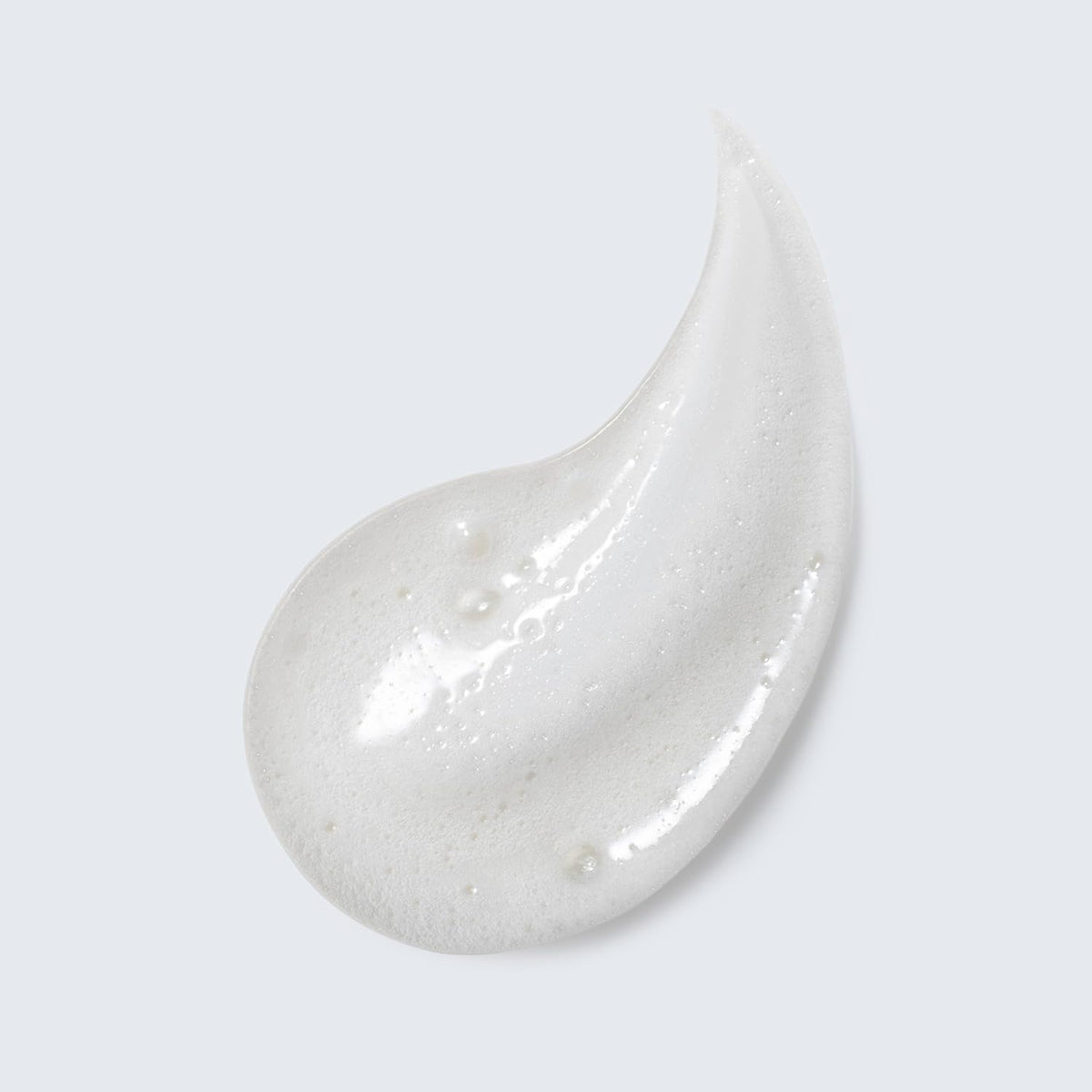 Estée Lauder creamy foam texture close-up showing lather and gentle cleansing action