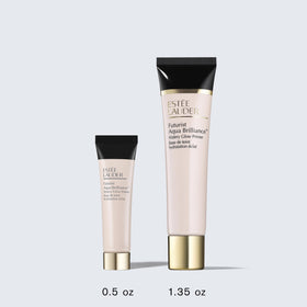 Estée Lauder primer styled on vanity with brushes suggesting radiant makeup prep
