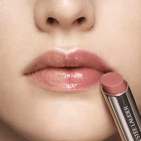 Estée Lauder open twist-up tube revealing balm tip and easy application benefit