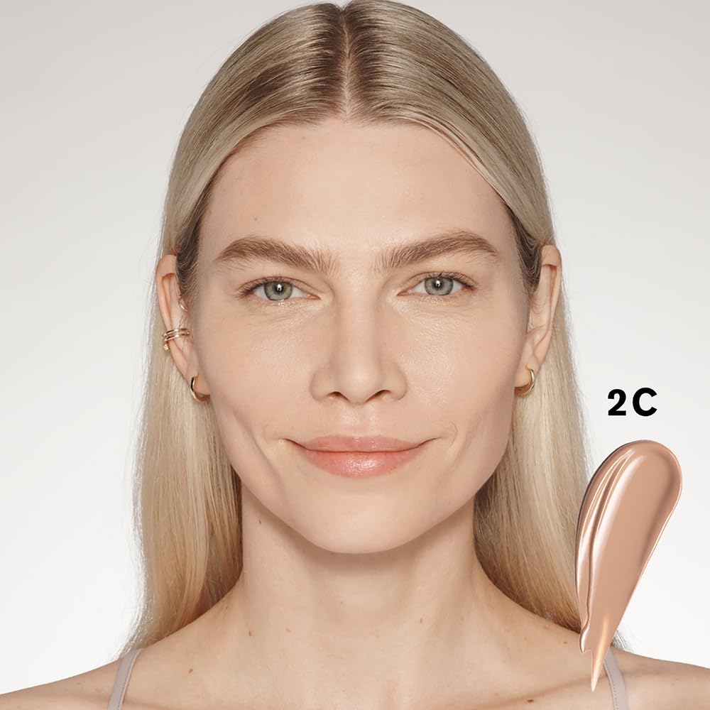 Estée Lauder tube held in hand to show compact scale and easy portability for on-the-go touchups