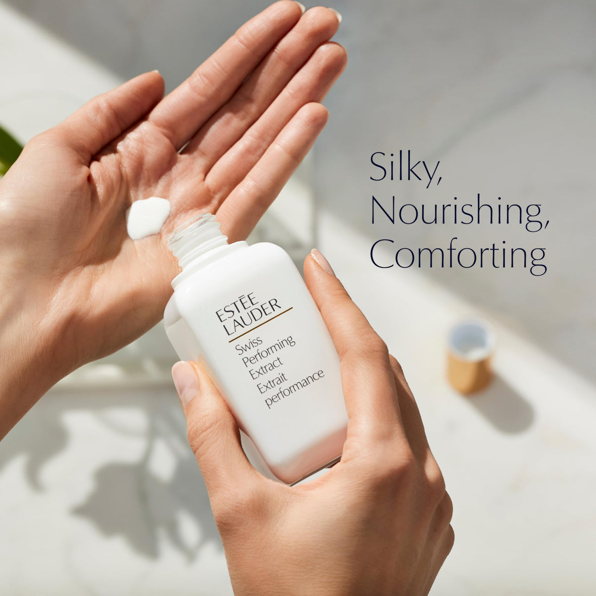 Estée Lauder lotion in hand being applied highlighting easy absorption