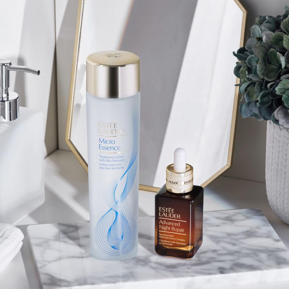 Estée Lauder bottle staged on bathroom shelf lifestyle scene showing routine-ready convenience