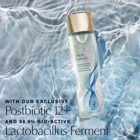 Estée Lauder essence drops on fingertip close-up, showing hydrating formula benefit