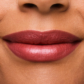 Estée Lauder texture swipe of Rebellious Rose on skin showing shimmer finish and smooth hydration