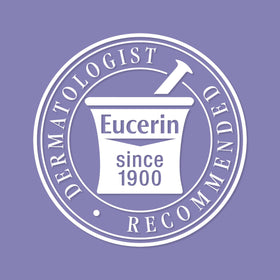 Eucerin bottle held in hand for scale showing compact 13.5 oz size