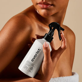 Everist lifestyle applying spritz on leg showing fast hydration and glow benefit