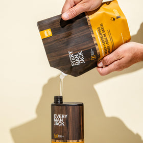 Every Man Jack pouch beside a standard bottle showing larger 36 oz refill value
