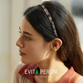EVITA PERONI headband worn during exercise demonstrating non-slip active-wear benefit