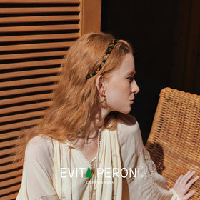 EVITA PERONI lifestyle shot styling headband with casual outfit for versatility