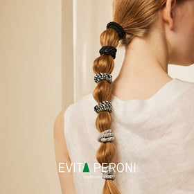 EVITA PERONI wrapped on a wrist as an accessory and easy carry option