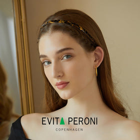 EVITA PERONI close-up of acetate texture highlighting glossy durable finish