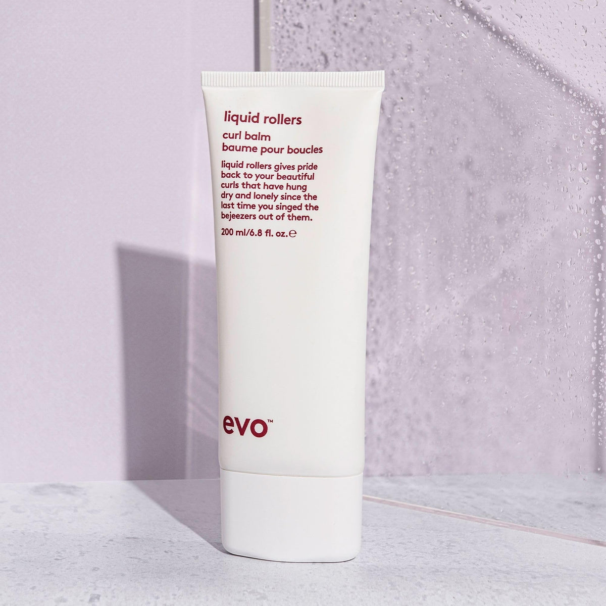EVO in lifestyle shot on curly hair showing improved definition and shine