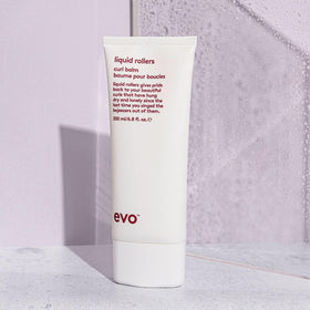 EVO in lifestyle shot on curly hair showing improved definition and shine