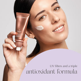 EXUVIANCE applying cream on hand demonstrating lightweight spreadability benefit