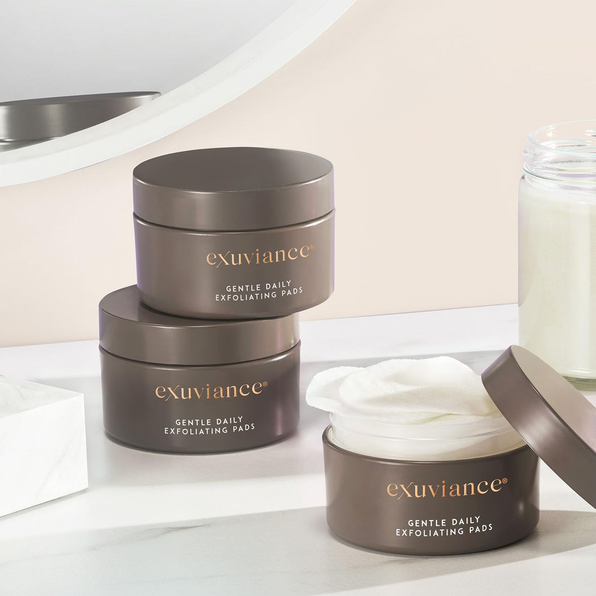 EXUVIANCE ingredient bottles of vitamin C and E supporting radiance