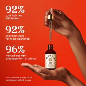 Fable & Mane oil texture and drops on hand, showing lightweight non-greasy feel
