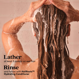 Fable & Mane shampoo in shower setting with towel, conveys everyday routine benefit