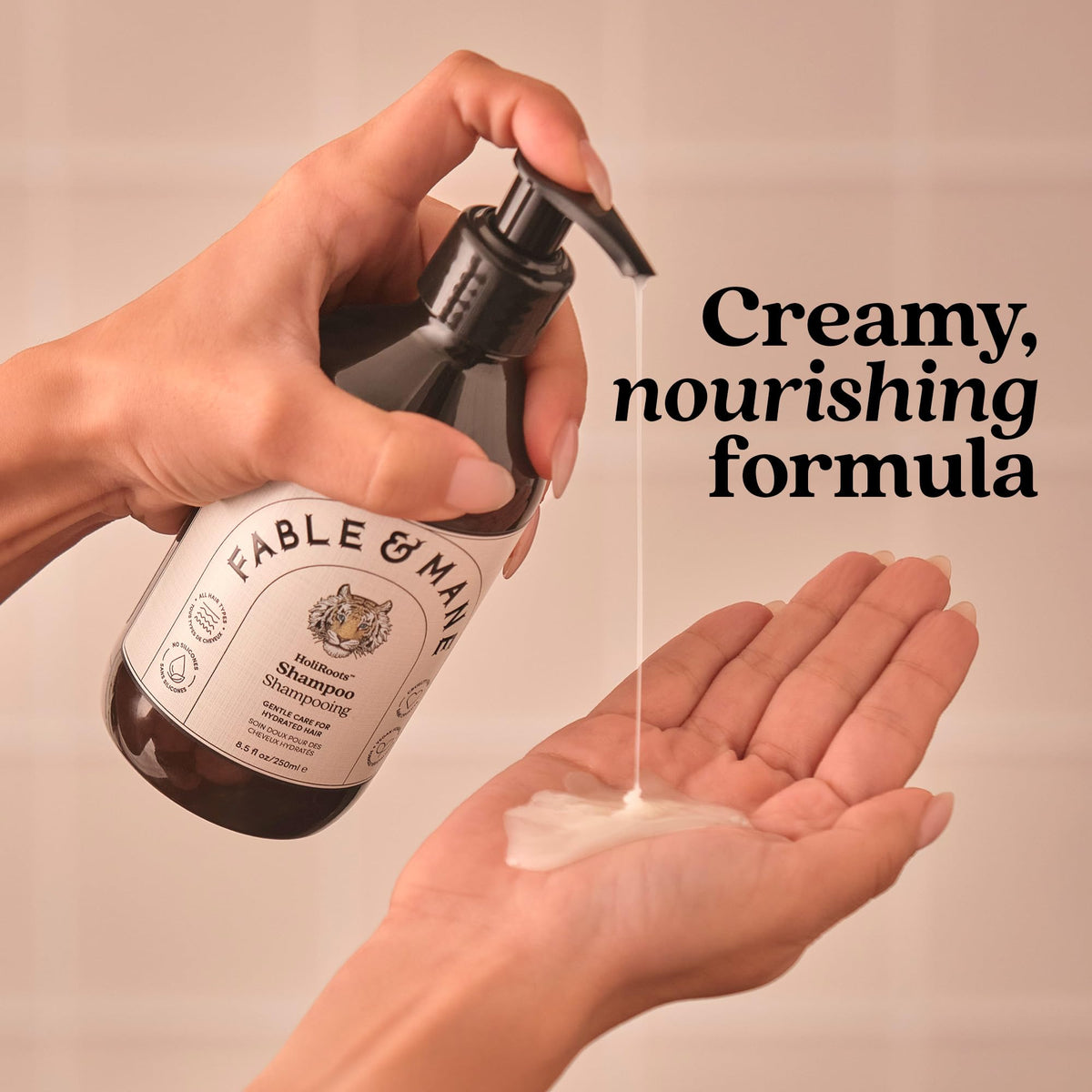 Fable & Mane coconut halves near bottle, illustrating smoothing coconut oil benefit