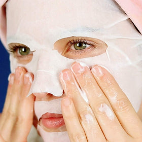 FACETORY mask held in hand indicating compact size and easy use