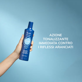 Fanola shampoo in use on wet hair in shower demonstrating brass-tone neutralizing action