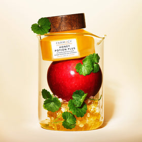Farmacy ingredients flatlay with honey, apple extract, and ceramides emphasizing natural actives