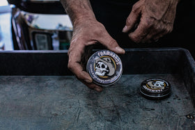 Farmhands tin next to tools showing work-ready protection and practicality