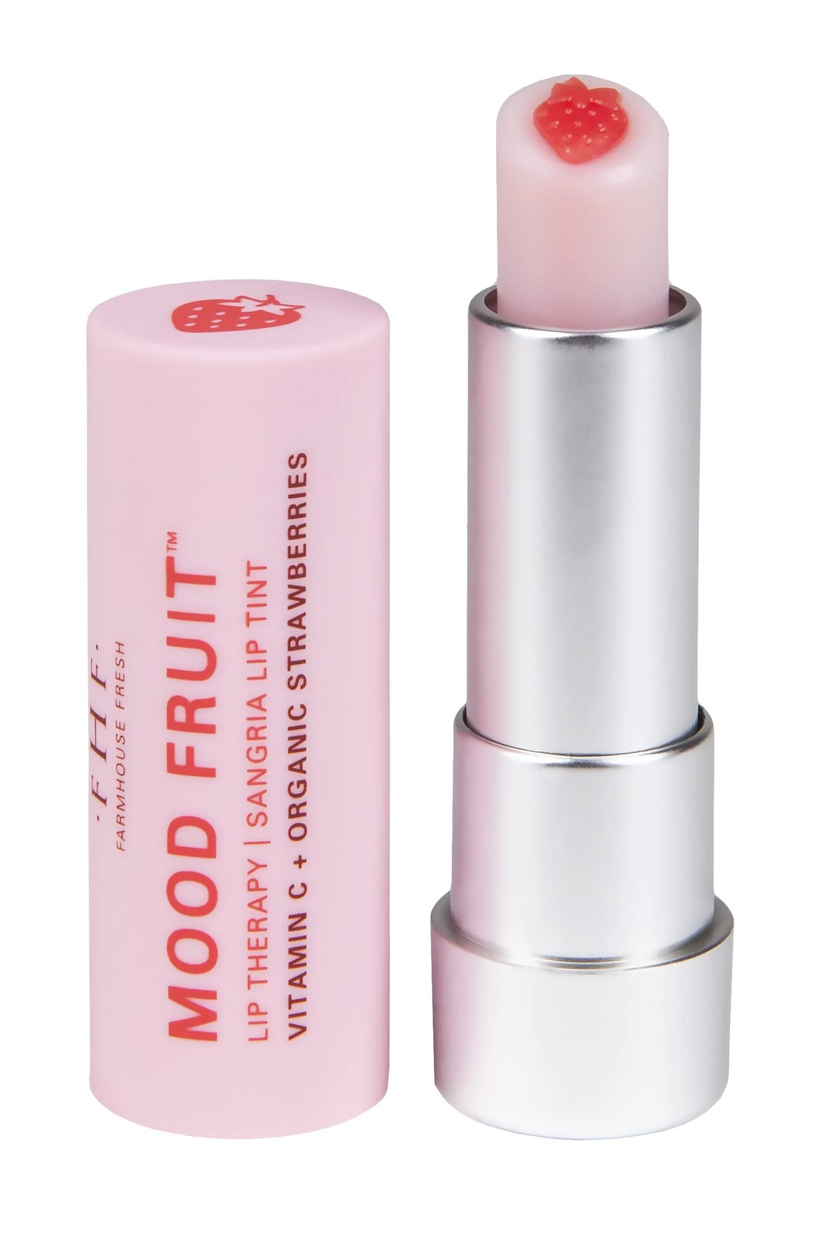 FarmHouse Fresh lip balm beside a coin for scale indicating travel-friendly size