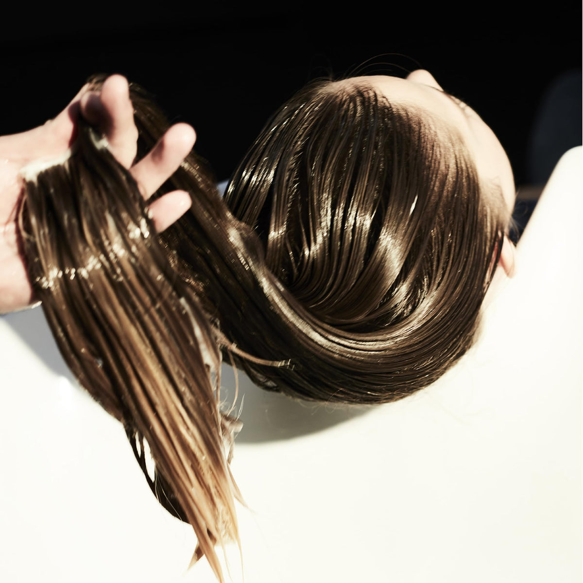 Fekkai product applied to hand demonstrating easy spread and styling benefit
