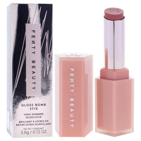 FENTY BEAUTY Gloss Bomb Stix held in hand illustrating compact size and travel ease