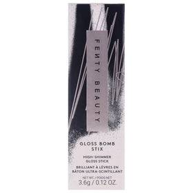 FENTY BEAUTY Gloss Bomb Stix beside clutch demonstrating on-the-go convenience and style