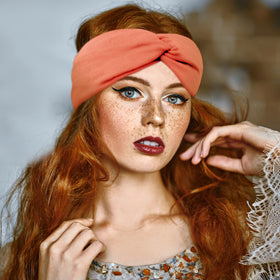 FEQO headband in hand to show size and stretchy scale for most head circumferences