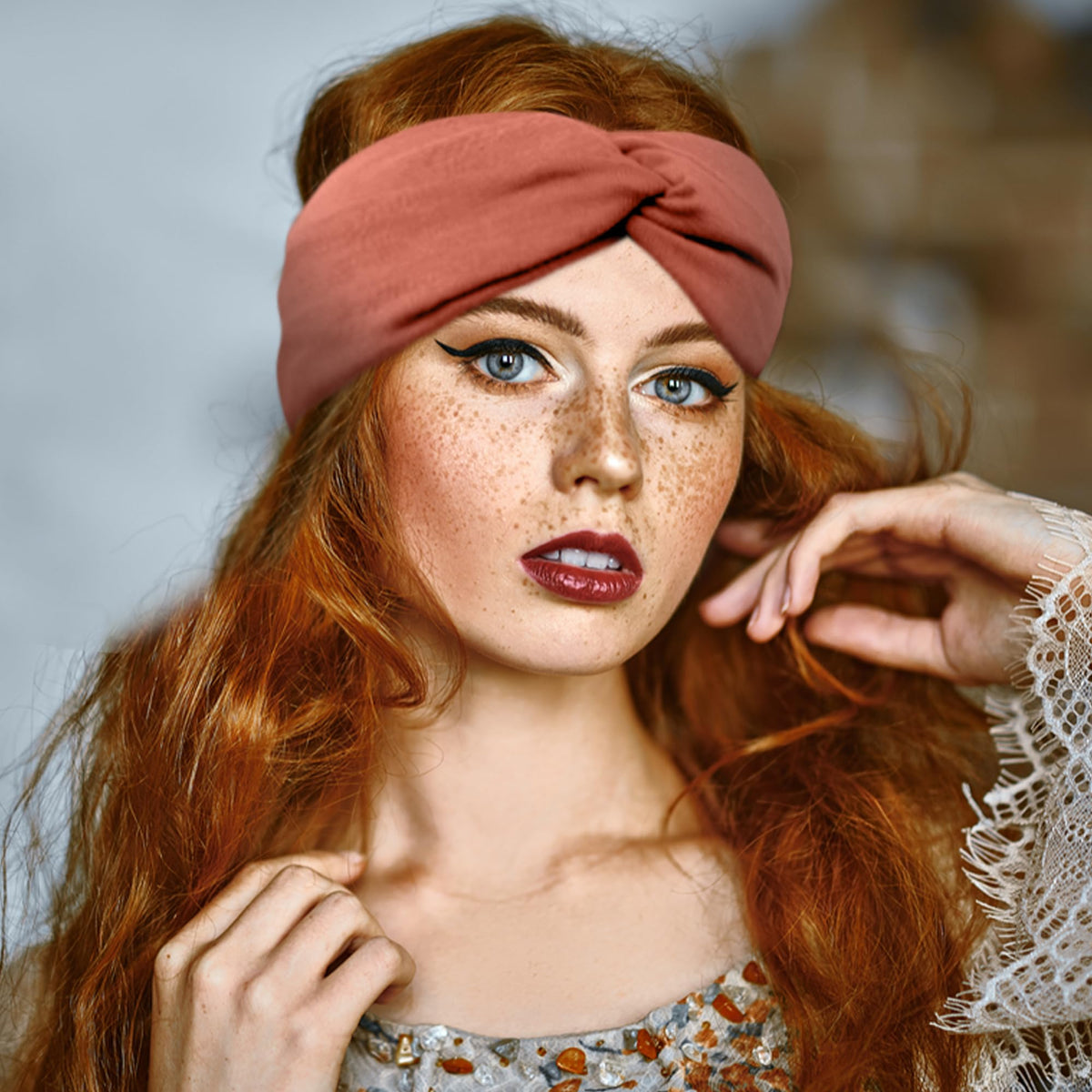 FEQO hand holding headband to show scale and easy portability